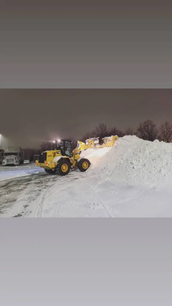 A machine picking up the snow from street